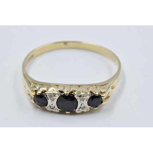 1066 - 9ct Yellow gold dress ring set three sapphires interspaced with diamonds, size S, 2.1g