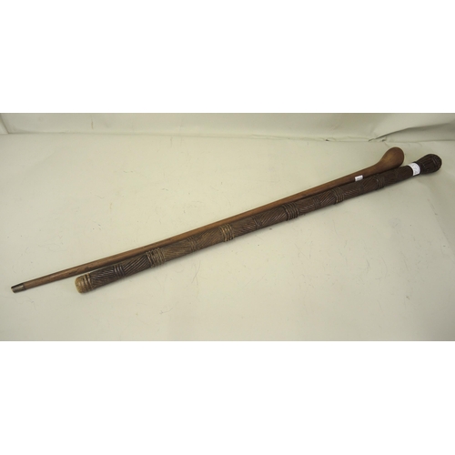 137A - African carved hardwood walking stick, 84cm long together with another plain stick with Arabic inscr... 