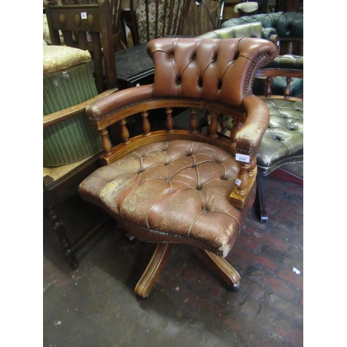 Reproduction brown button leather upholstered swivel office chair (upholstery at fault)