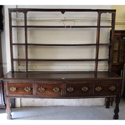 2045 - 18th Century oak dresser, the open shelved back above a moulded top with four short drawers, having ... 