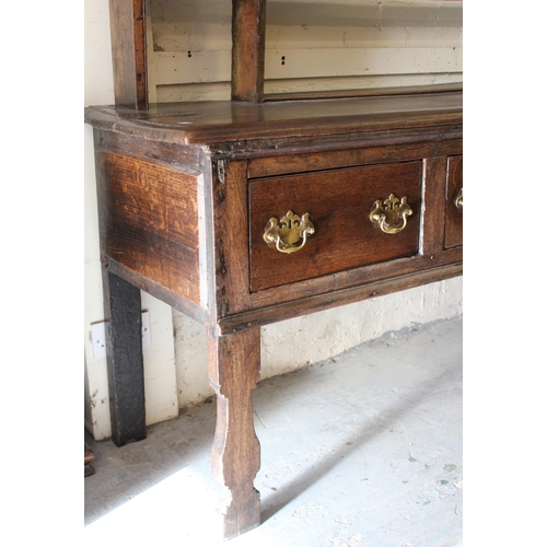 2045 - 18th Century oak dresser, the open shelved back above a moulded top with four short drawers, having ... 