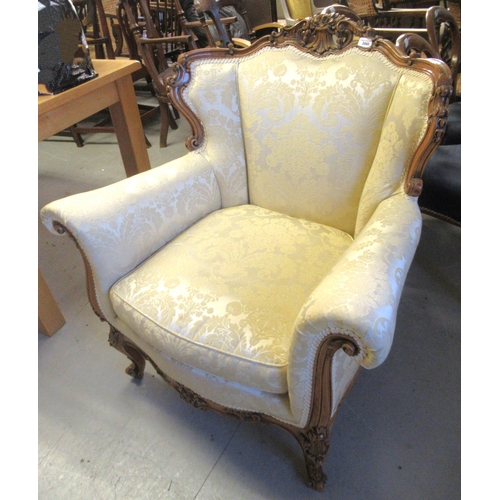 2060 - 20th Century French carved walnut and cream upholstered armchair on cabriole supports