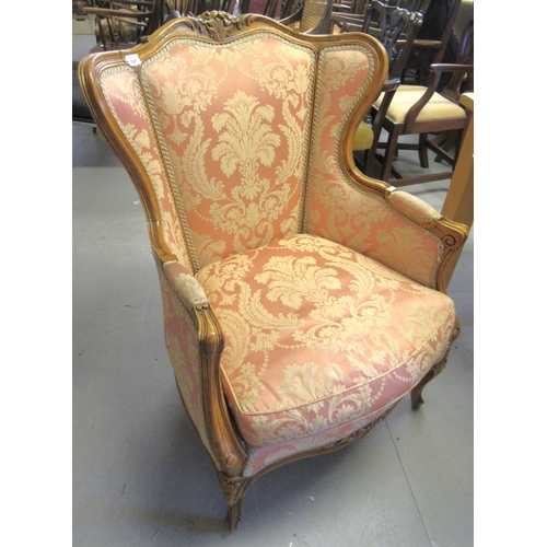 2061 - 20th Century French carved walnut and pink upholstered armchair