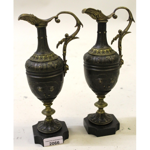 2066 - Pair of 19th Century French bronze ewers on black slate bases, 25.5cm high