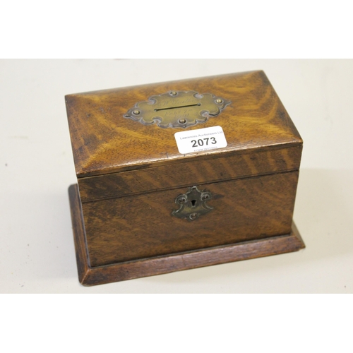 2073 - Small oak money box having hinged cover engraved A.W. Guillan, February 7th, 1891