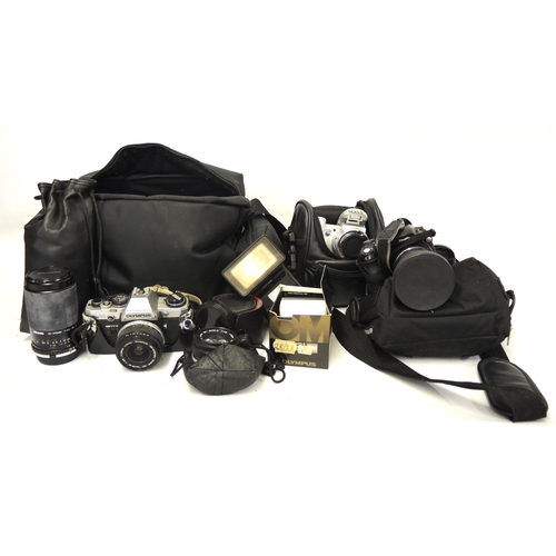 250 - Olympus OM10 SLR camera outfit with various lenses and accessories, together with two other cased ca... 