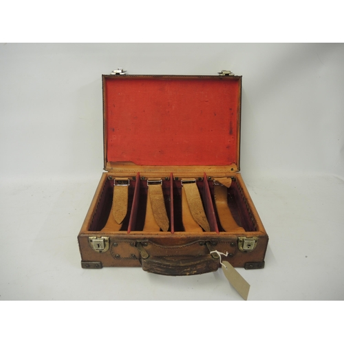 319 - Leather cartridge case with metal mounts, the hinged cover enclosing a fitted interior, 33cm wide