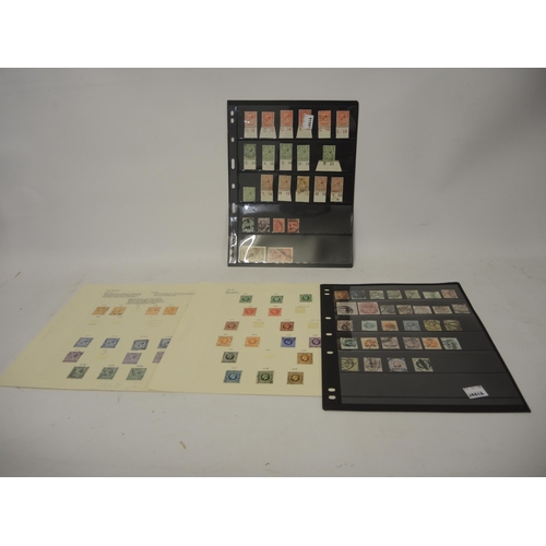 335 - Four loose leaves of Victorian high value stamps and a green album of World stamps