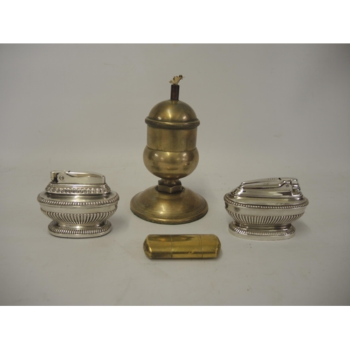 348 - Heavy bronze table lighter, two silver plated table lighters and a brass cased lighter