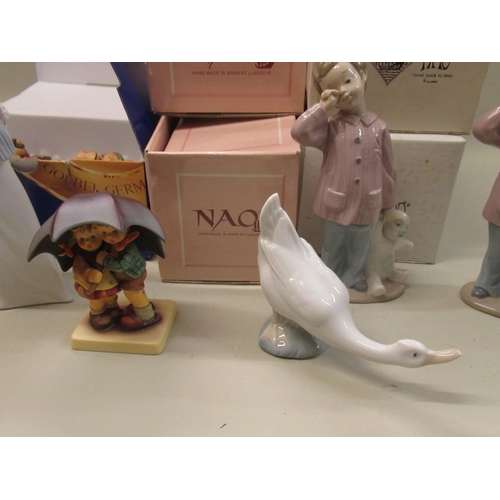 697 - Two Nao figures of a small boy with a teddy bear, in original boxes, two other Nao figures, boxed, a... 