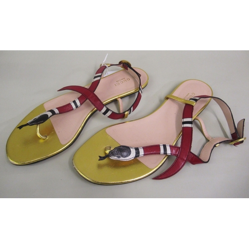 79 - Gucci, pair of flat leather sandals, the top in the form of a snake, size 39, with original dust bag