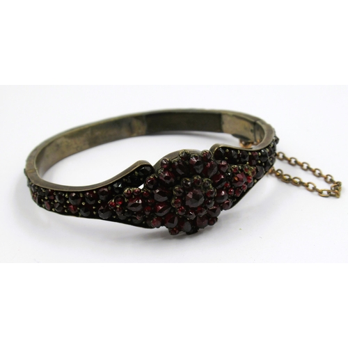 858 - Continental white metal and garnet set bangle (at fault)