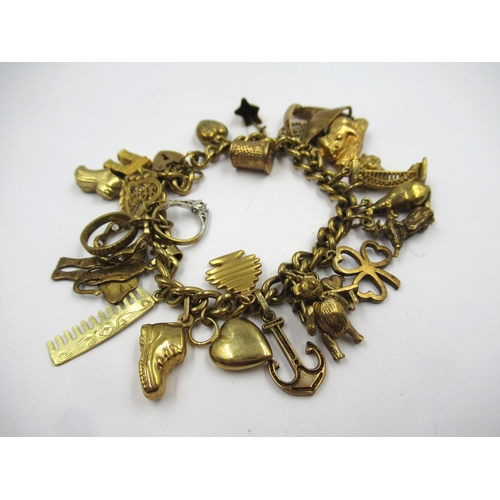 885 - 9ct Yellow gold charm bracelet mounted with various charms