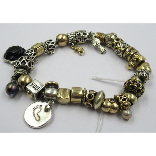 890 - Pandora charm bracelet with multiple 9ct gold, 15ct gold and silver charms, gross weight 87.8g