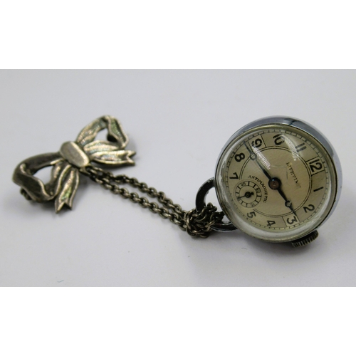 899 - Silver plated ball watch suspended from a bow