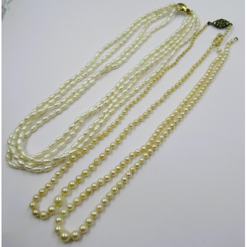 900 - Two graduated cultured pearl necklaces (one at fault), together with a freshwater pearl necklace