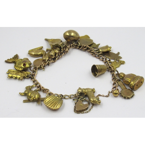 940 - 9ct Yellow gold charm bracelet on 9ct yellow gold chain, including some 14ct and 15ct gold charms, 2... 