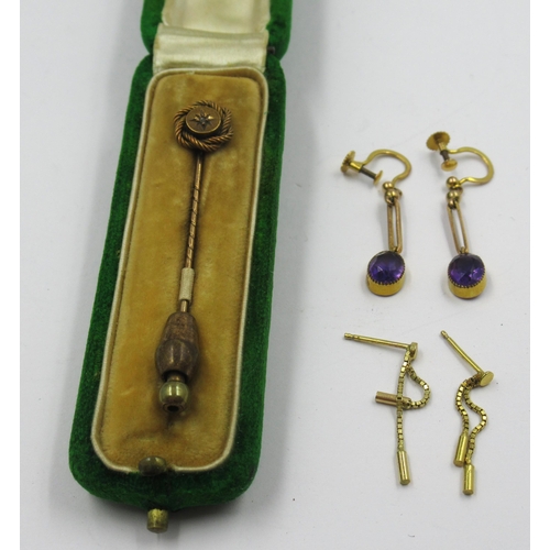 945 - Gold stick pin (boxed) together with two small pairs of yellow metal earrings