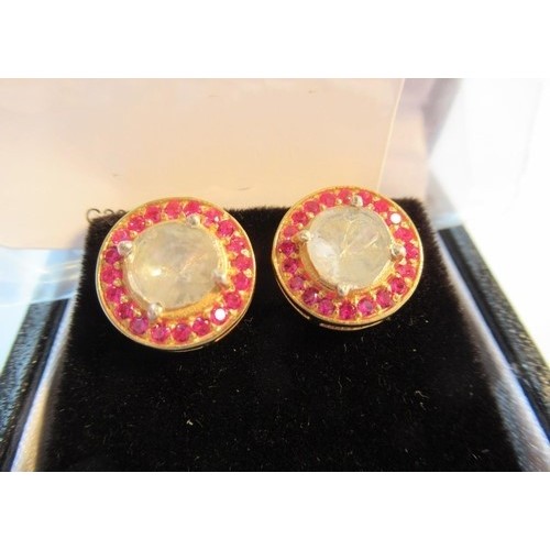 1046 - Pair of silver gilt circular stud earrings set with old flat cut diamonds and a halo of rubies, toge... 