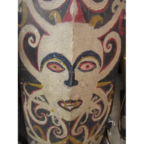 225 - African wooden tribal shield, painted with a mask head, 131cm high