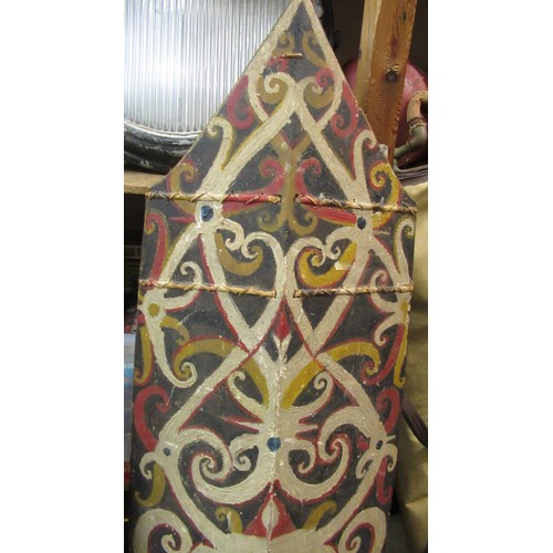 225 - African wooden tribal shield, painted with a mask head, 131cm high