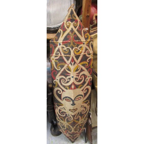 225 - African wooden tribal shield, painted with a mask head, 131cm high