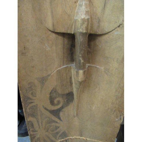 225 - African wooden tribal shield, painted with a mask head, 131cm high