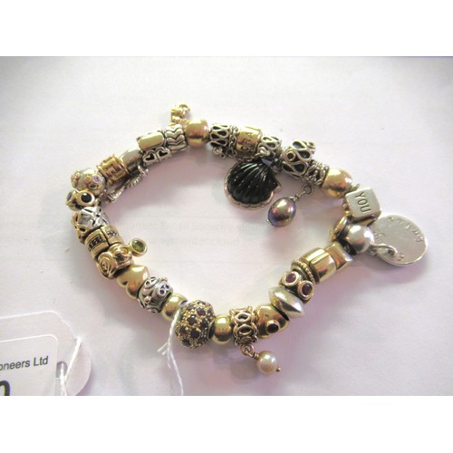 890 - Pandora charm bracelet with multiple 9ct gold, 15ct gold and silver charms, gross weight 87.8g