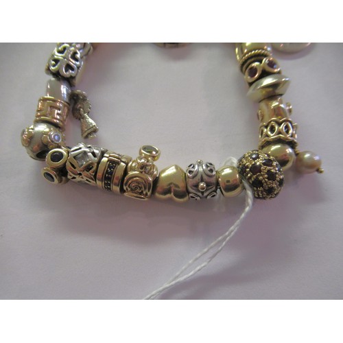 890 - Pandora charm bracelet with multiple 9ct gold, 15ct gold and silver charms, gross weight 87.8g