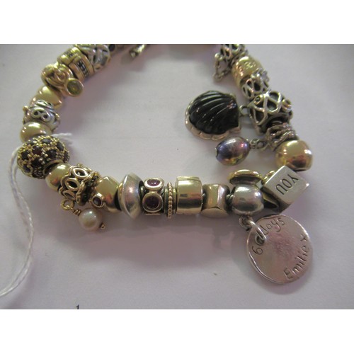 890 - Pandora charm bracelet with multiple 9ct gold, 15ct gold and silver charms, gross weight 87.8g