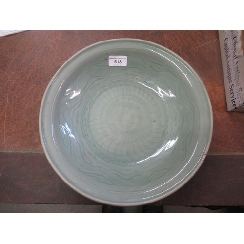 513 - Chinese Celadon circular deep dish with shallow incised decoration, 32cm diameter, with a hardwood s... 