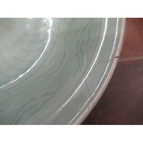 513 - Chinese Celadon circular deep dish with shallow incised decoration, 32cm diameter, with a hardwood s... 