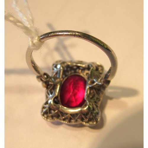 1035 - Early 20th Century oval treated or synthetic ruby and diamond dress ring, the ruby approximately 10m... 