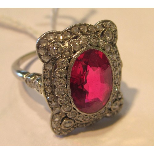 1035 - Early 20th Century oval treated or synthetic ruby and diamond dress ring, the ruby approximately 10m... 