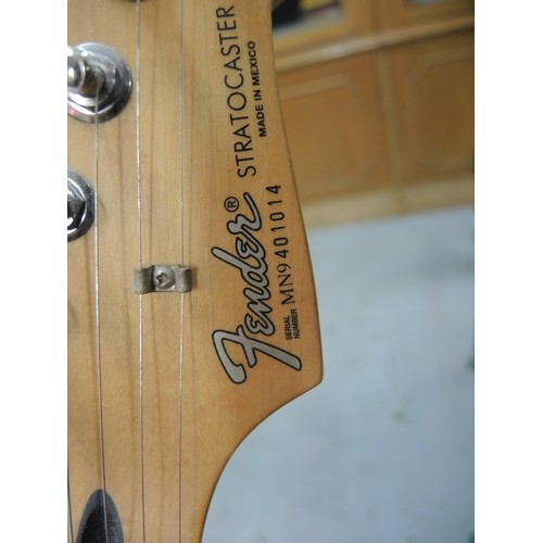 256 - Fender Stratocaster (made in Mexico) with a maple neck and fingerboard, deep red body, in a fitted c... 