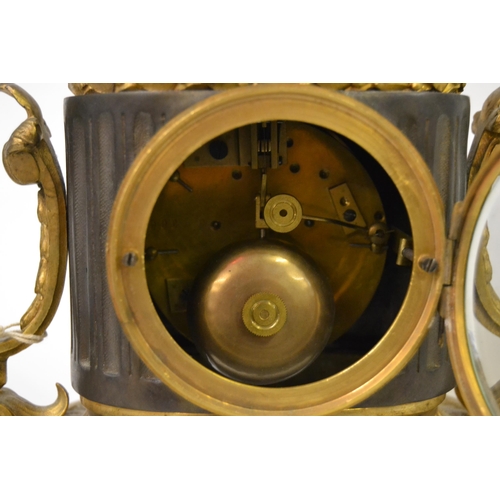 1041 - 19th Century bronze and gilt metal mantel clock, surmounted with a figure of a bird having circular ... 