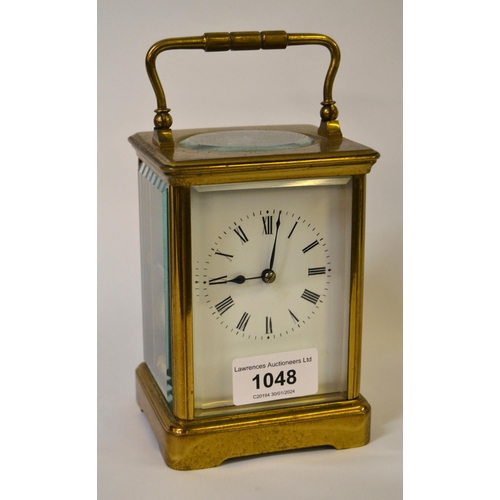 French gilt brass carriage clock, the enamel dial with Roman numerals, with a two train movement striking on the half hour