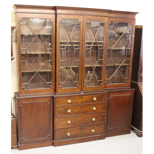 George III mahogany breakfront bookcase with moulded cornice above four astragal glazed doors, the base with four central drawers flanked by two panelled doors on a plinth base, 214cm wide x 39cm deep x 229cm high