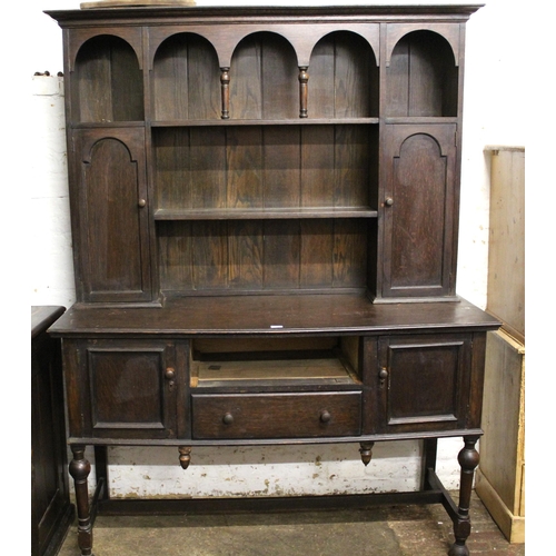 Early 20th Century oak dresser with a boarded shelf and cupboard back above drawers and cupboard doors