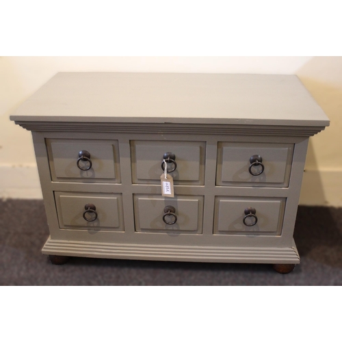 Floorstanding low bank of eight drawers with iron ring handles, on bun feet