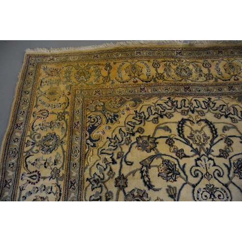 18 - Nain carpet with a medallion and all-over floral design on a beige ground with borders (some moth da... 