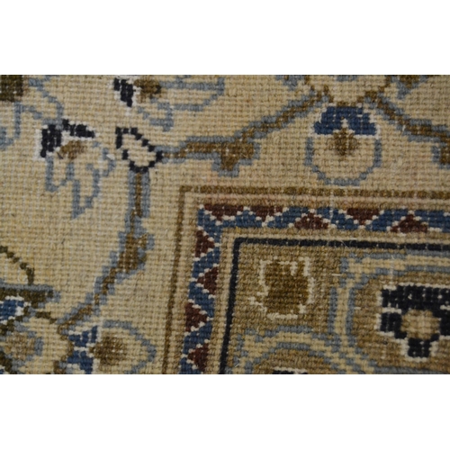 18 - Nain carpet with a medallion and all-over floral design on a beige ground with borders (some moth da... 