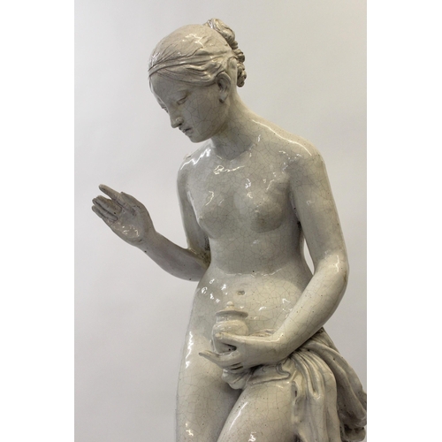 426 - Large 20th Century white crackle glazed pottery figure of a semi nude girl on an oval plinth base