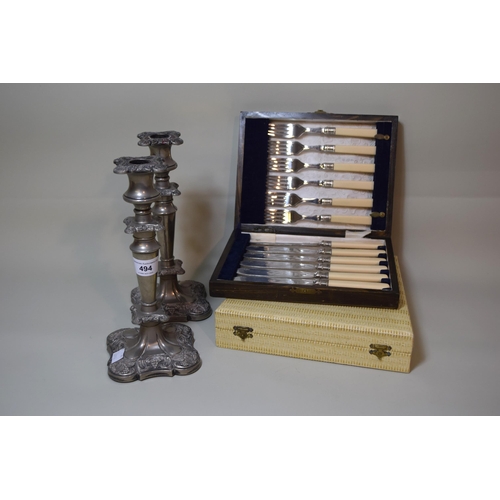 494 - Pair of silver plated candlesticks and two cased sets of plated flatware