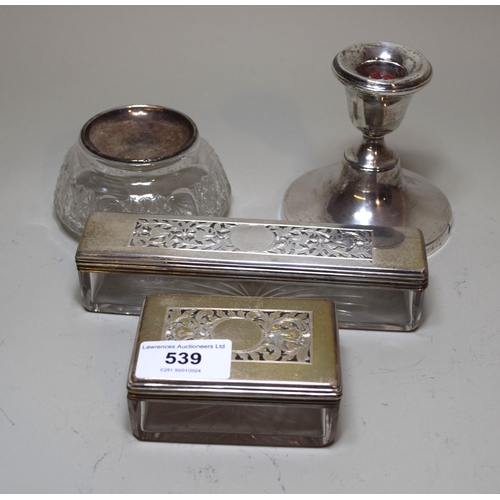 Two William IV silver topped glass vanity case jars, together with a cut glass jar with associated silver cover and silver dwarf candlestick