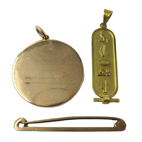 595 - Unmarked yellow metal locket, 12.5g gross, together with an Egyptian yellow metal pendant, 2.5g and ... 