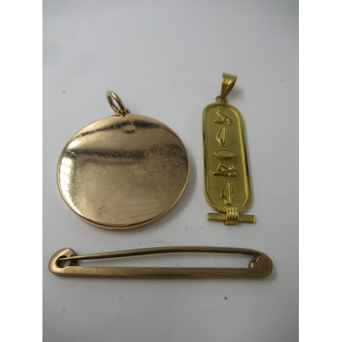 595 - Unmarked yellow metal locket, 12.5g gross, together with an Egyptian yellow metal pendant, 2.5g and ... 