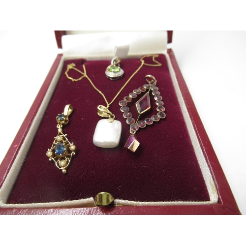 603 - 9ct Gold and cultured pearl pendant on chain, two small 9ct gold and gem set pendants and a garnet p... 