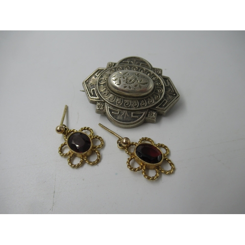 604 - Pair of 9ct gold and garnet earrings, together with a Victorian white metal brooch