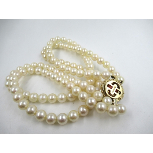 612 - Double row uniform cultured pearl necklace with a 9ct gold carved coral and cultured pearl set clasp... 